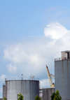 Cameroon, Douala: oil industry - fuel storage tanks in Douala harbor - tank farm, crane and ship in the background - Boulevard du Gnral Leclerc 27 Aot 1940 - photo by M.Torres