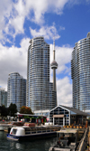 Toronto, Ontario, Canada: view from York Quay - The Waterclub condominium, CN Tower, Second Cup caf and Miss Kim Simpson tour boat - photo by M.Torres