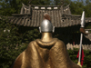 Lijiang, Yunnan Province, China: Dragon Park - golden warrior and traditional roof - photo by M.Samper