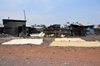 Goma, Nord-Kivu, Democratic Republic of the Congo: cereals drying by the roadside - slum - wood and zinc huts - photo by M.Torres