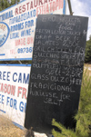 Greece, Karpathos - Adeia:quirky menu at beach side restaurant - black board - photo by P.Hellander