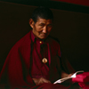 India - Dharamsala (Himachal Pradesh): Tibetan monk with Dalai Lama amulet - photo by W.Allgower