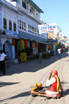 Pushkar, Rajasthan, India: beggar and Lake View hotel - photo by M.Wright