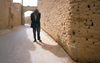 Iran - Yazd: an elderly man slowly walks along the old streets of the desert city - photo by W.Allgower