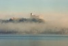 Angera (Lombardy / Lombardia - Varese province): Rocca castle lost in the mist - Lago Maggiore (photo by Miguel Torres)