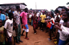 Grand Bassa County, Liberia, West Africa: masked man and crowd - photo by M.Sturges