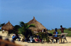 Grand Bassa County, Liberia, West Africa: village life - bamboo benches and thatched roof huts - photo by M.Sturges