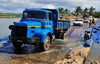 RN5, Ambodibonara, Atsinanana region, Toamasina Province, Madagascar: floating bridge over the River Onibe - Renault truck tests the limits of the pontoon bridge - photo by M.Torres