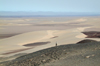 Namibia: Person walking at scenic overlook, Skeleton Coast - photo by B.Cain