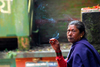 Kathmandu valley, Nepal: Dakshinkali temple complex, dedicated to the Hindu goddess Kali - local woman smoking - photo by J.Pemberton