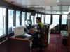 New Zealand - South island: Milford track - Captain at bridge of Milford Mariner - photo by Air West Coast