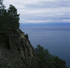 Lake Baikal, Irkutsk oblast, Siberia, Russia: pine trees and basalt rocks on the eastern shore of Olchon Island in Lake Baikal - natural sculpted cliffs - photo by A.Harries