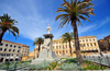 Sassari / Tthari, Sassari province, Sardinia / Sardegna / Sardigna: Piazza d' Italia - palm trees and statue of Vittorio Emanuele II, symbol of the Italian Risorgimento - Palazzo della Provincia in the background - photo by M.Torres