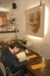 Girl looking at menu in cafe / bar Bistro Ambient, Ljubljana , Slovenia - photo by I.Middleton