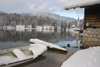 Slovenia - Ribcev Laz - frozen boat - view across Bohinj Lake in winter - photo by I.Middleton