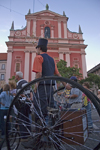 Old fashioned postman and Franciscan Church of the Annunciation, Ljubljana - photo by I.Middleton