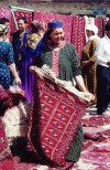 Turkmenistan - Ashghabat: Turkmen carpets at the market - ldy with rug - photo by G.Frysinger