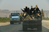 Wadi Hadhramaut, Hadhramaut Governorate, Yemen: women in abayas and traditional straw hats going to work in the fields - conical witches hats, known as madhalla - trucks on the road - photo by J.Pemberton