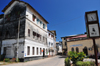 Stone Town, Zanzibar, Tanzania: UNESCO clock and Victoria Gardens - originally laid out by Sultan Barghash for the recreation of his harem - Kaunda rd. - clock - buildings of the Communications Regulatory Authority and Zanzibar Insurance corporation - Vuga area - photo by M.Torres