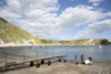 Lulworth Cove, Dorset, England: men dragging boat up beach - photo by I.Middleton