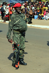 Bissau, Guinea Bissau / Guin Bissau: Avenida Amlcar Cabral, Empire Square, Carnival, man masked as a soldier - sling shot / Avenida Amilcar Cabral, homem mascarado de militar armado com uma fisga - photo by R.V.Lopes