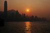 Hong Kong: Hong Kong island skyline at sunset, over the water - photo by M.Torres