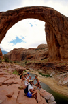 Lake Powell, Utah, USA: People dwarfed by Rainbow Bridge National Monument - the largest natural bridge in the world - San Juan County - photo by C.Lovell