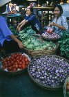 Selling at the vegetable market  (photo by Joe Filshie)